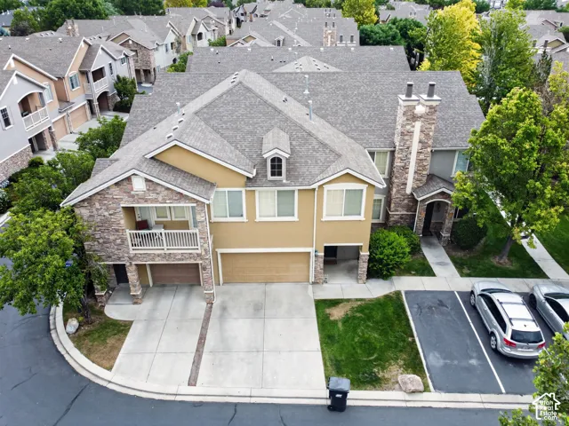 Multi-story residence featuring stone veneer and stucco siding