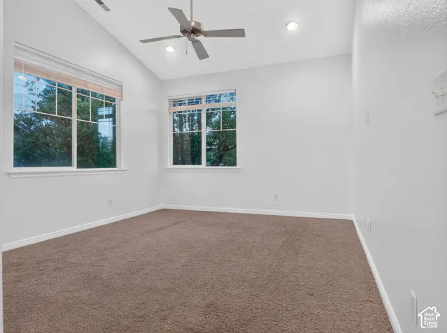 Vaulted ceiling with recessed lighting and ceiling fan