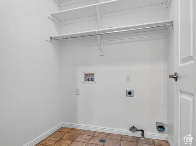 Built-in shelving and hanging rod with tile flooring