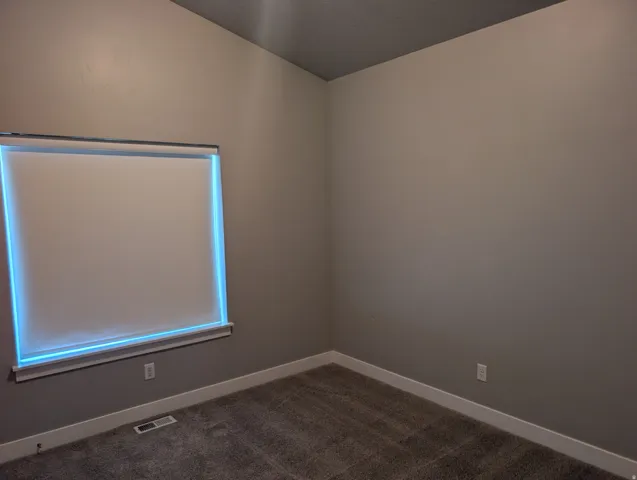 Neutral-toned walls complement plush carpeting in this interior space