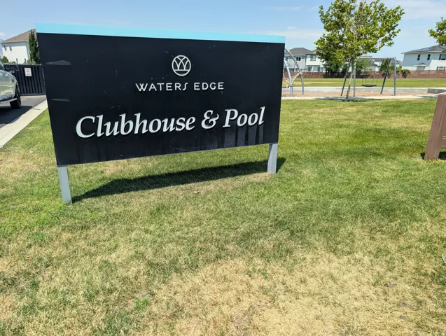 Community sign indicating "Waters Edge Clubhouse & Pool" amenities