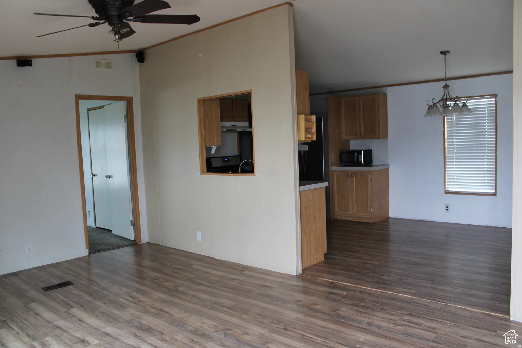 Open concept living area featuring wood-finish flooring