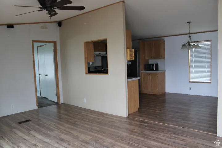 Open concept living area featuring wood-finish flooring