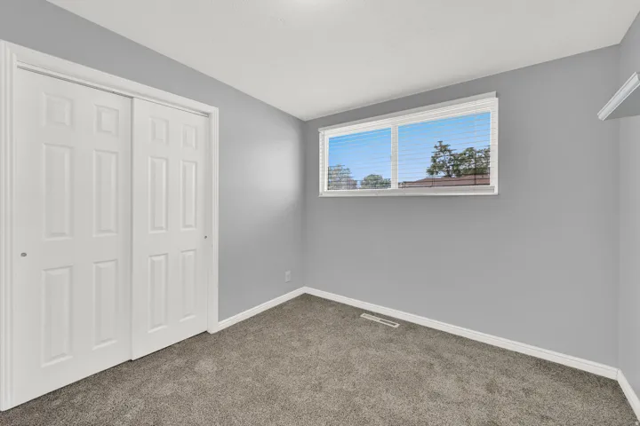 Neutral gray wall paint and white trim create a clean aesthetic