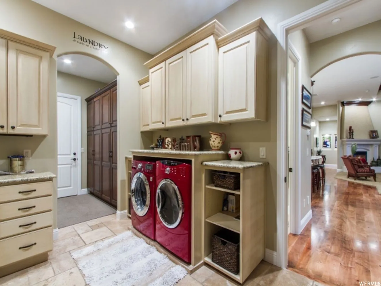Utility room featuring built-in cabinetry, stone-finish countertops, and tile flooring