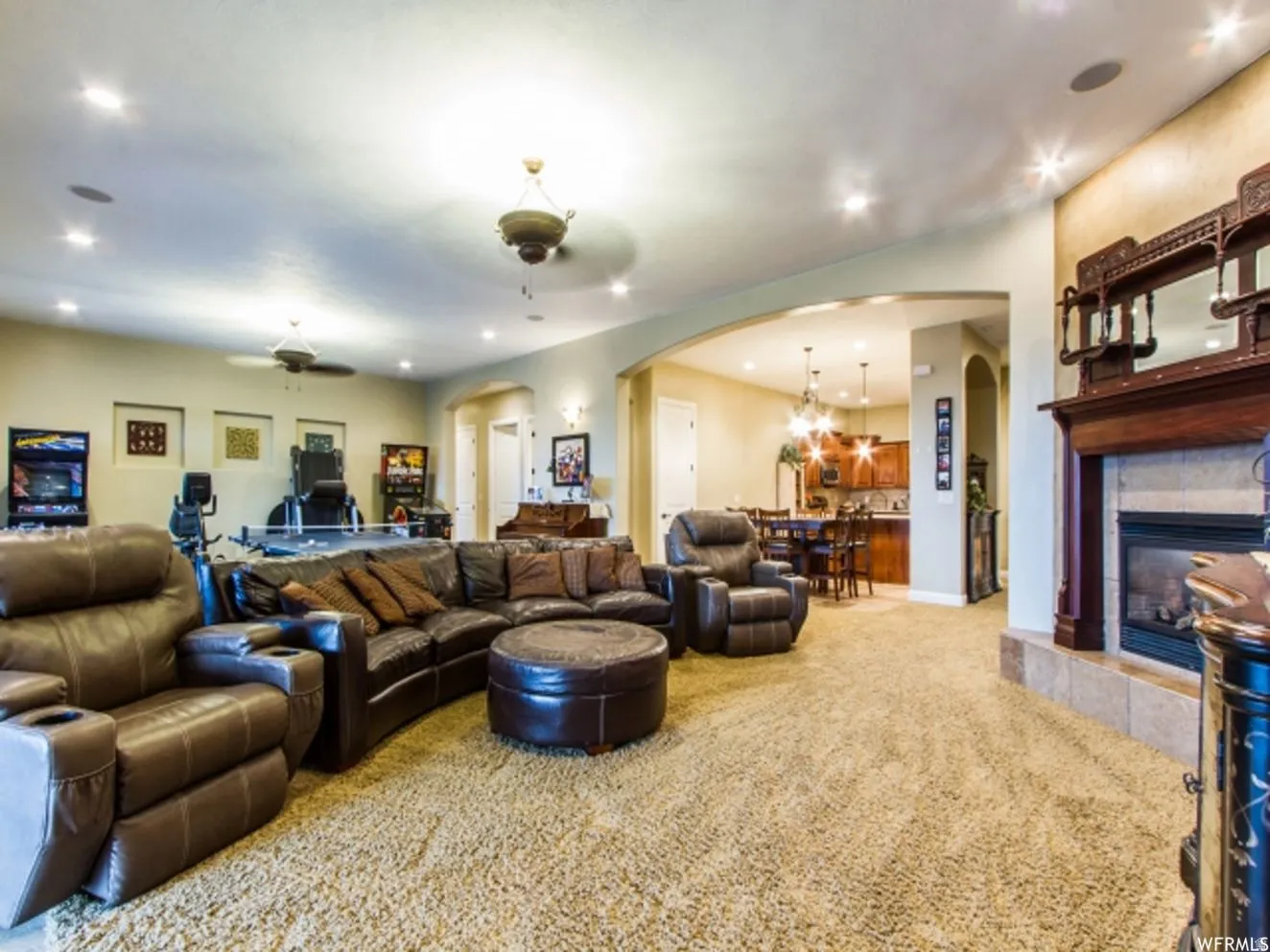 Spacious entertainment area with recessed lighting, integrated ceiling speakers, and light-toned wall finishes
