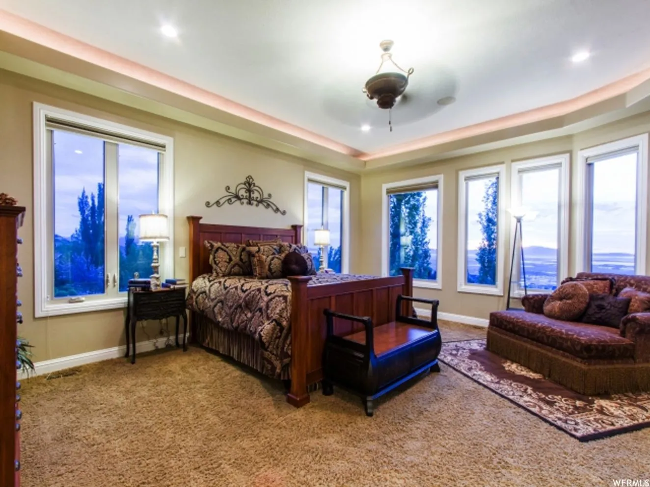 Recessed lighting illuminates a tray ceiling with cove lighting