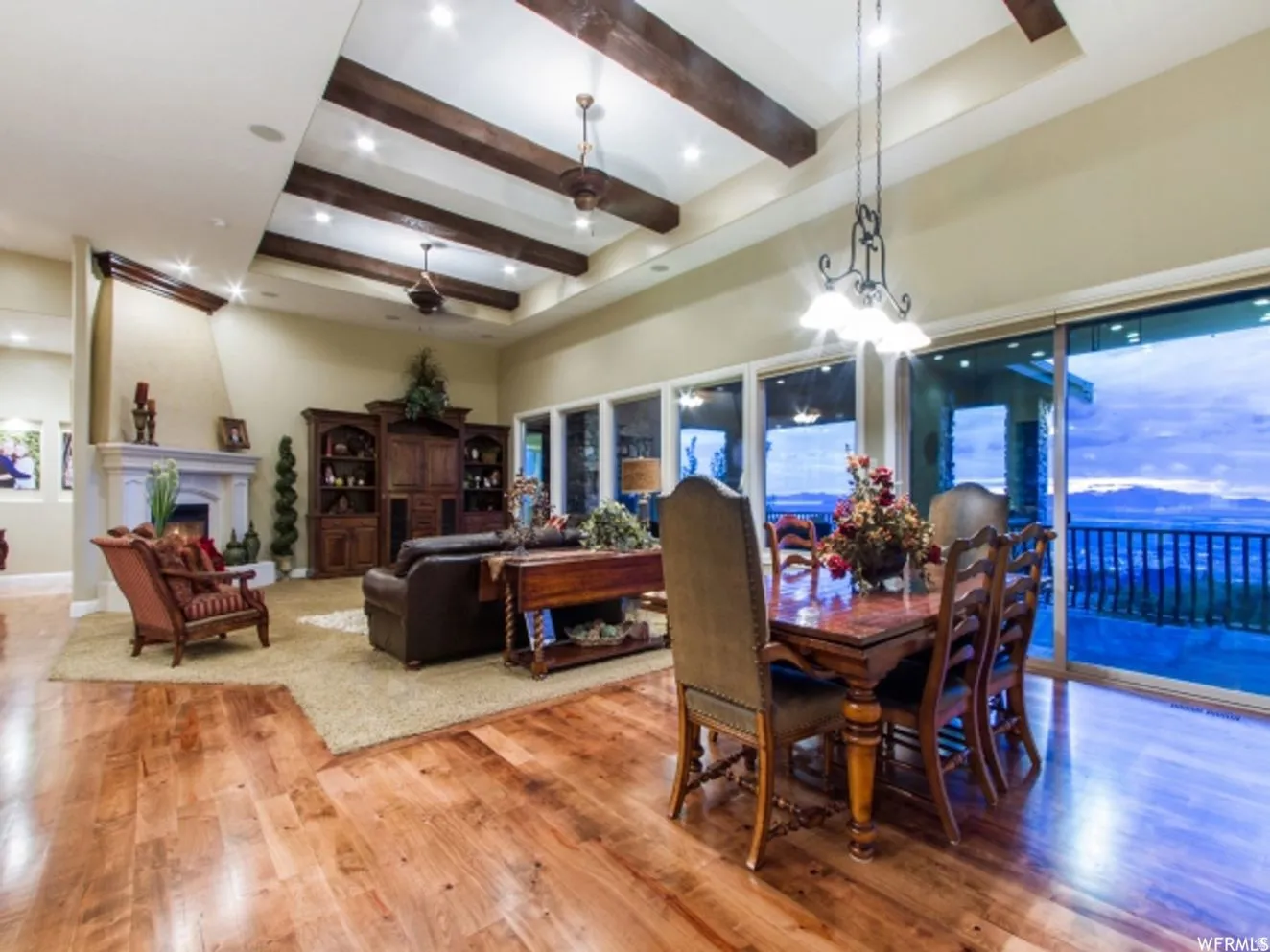 Vaulted ceiling with exposed wood beams and recessed lighting