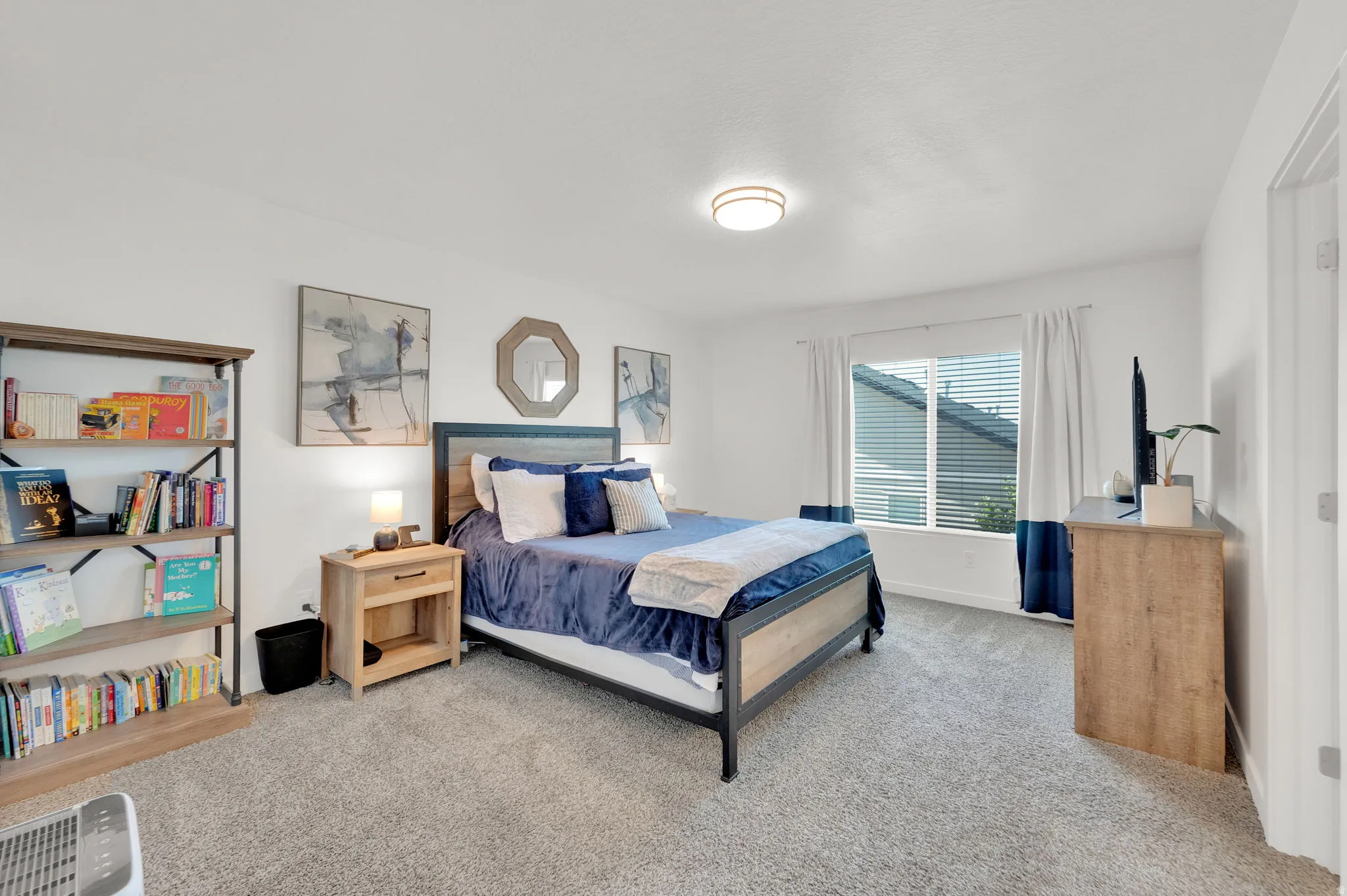 Spacious room featuring neutral carpet flooring, recessed lighting, a large window with white blinds, and crisp white walls