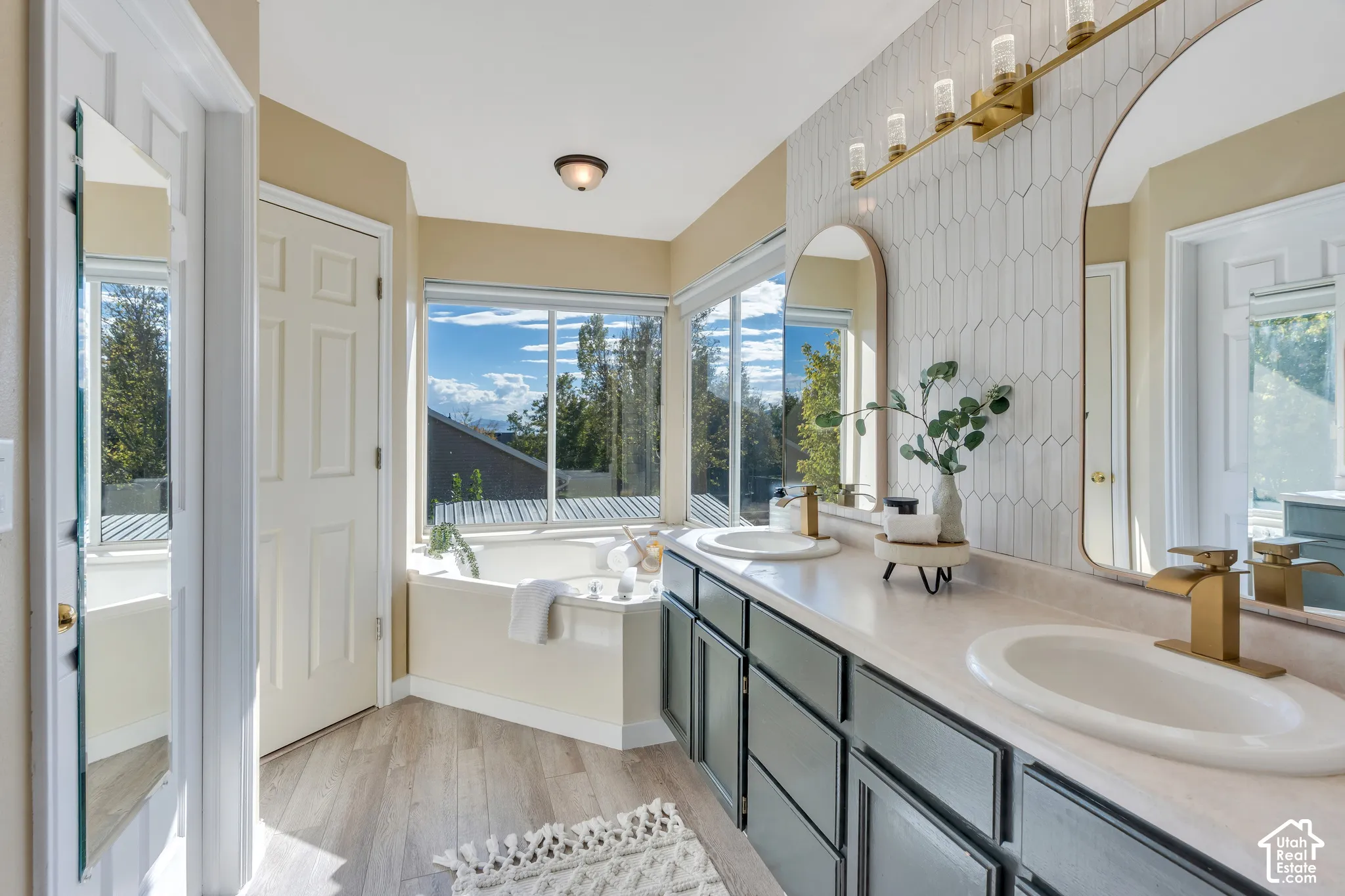 With updated backsplash, fresh painted cabinets, a relaxing soaking tub and separate toilet/shower room!