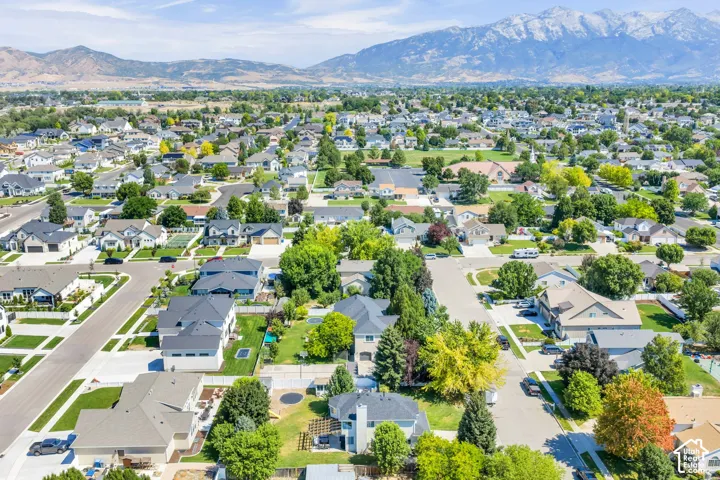 Expansive residential landscape featuring a variety of single-family homes, mature trees, and paved streets