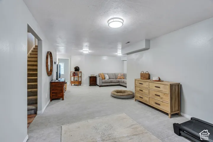 Spacious lower-level area featuring light-toned carpeting and neutral wall finishes