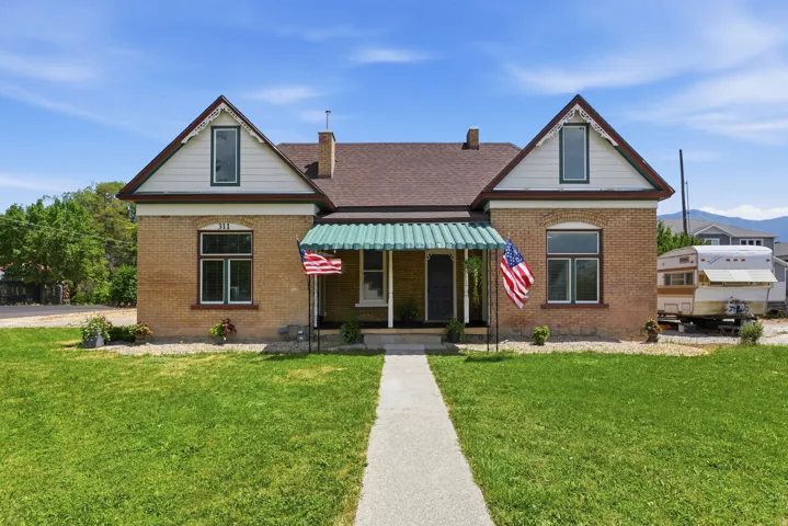 Brick exterior featuring a gabled roofline and decorative trim