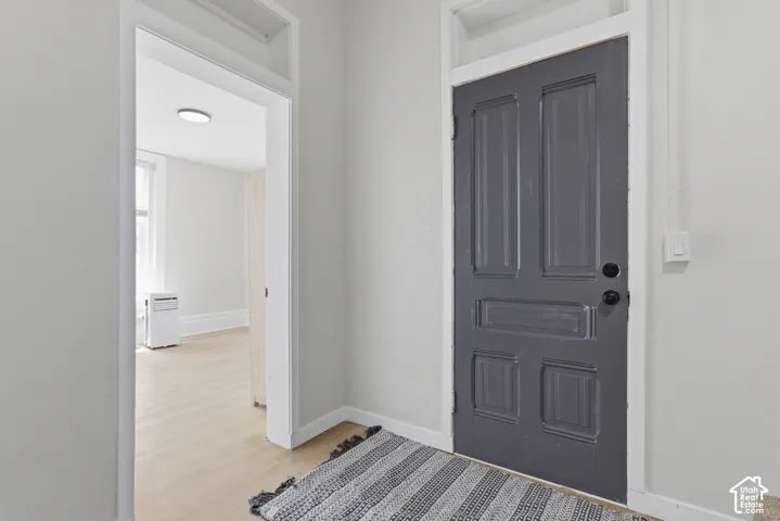 Panel door with dark finish, white trim, and light wall tones