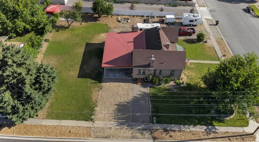 Single-story residence with a red metal roof and a brown shingle roof section