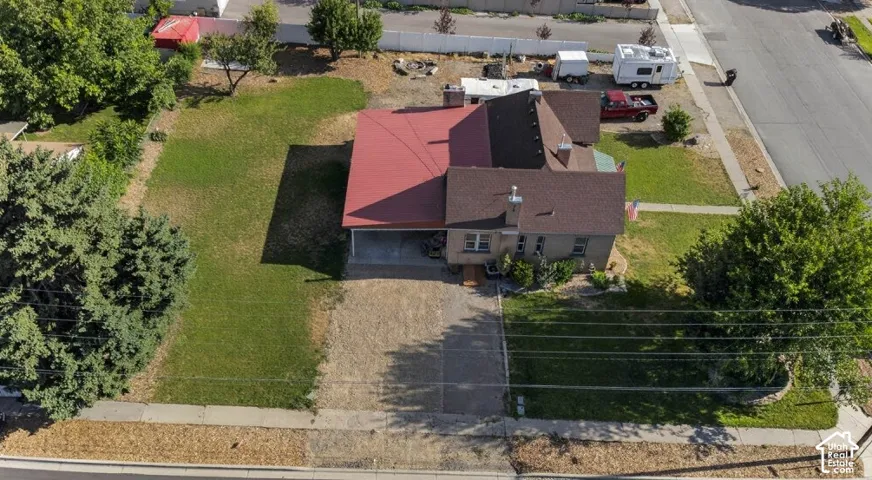 Single-story residence with a red metal roof and a brown shingle roof section
