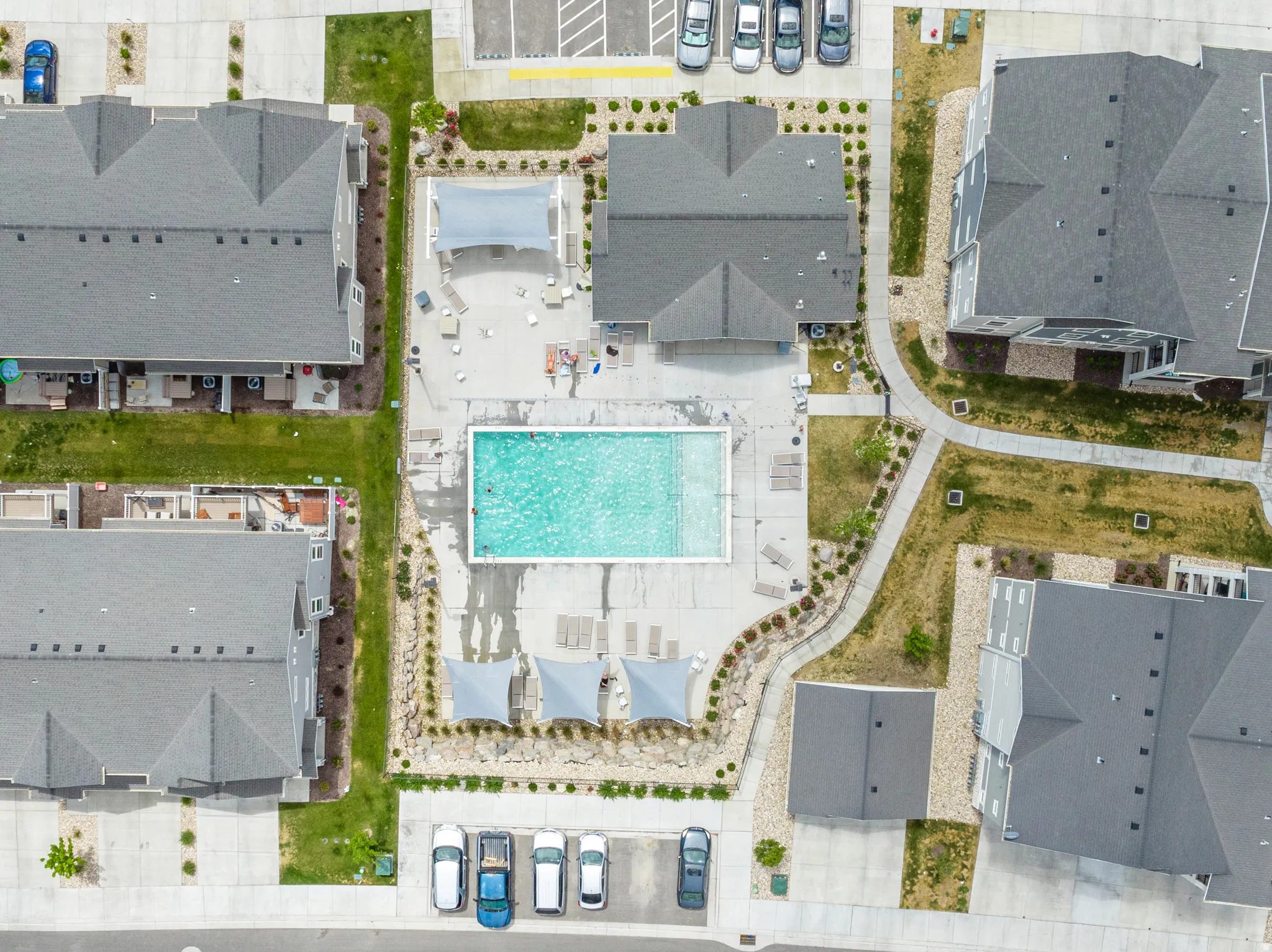 Central aquatic area featuring a rectangular swimming pool, surrounding lounge seating, and shaded zones