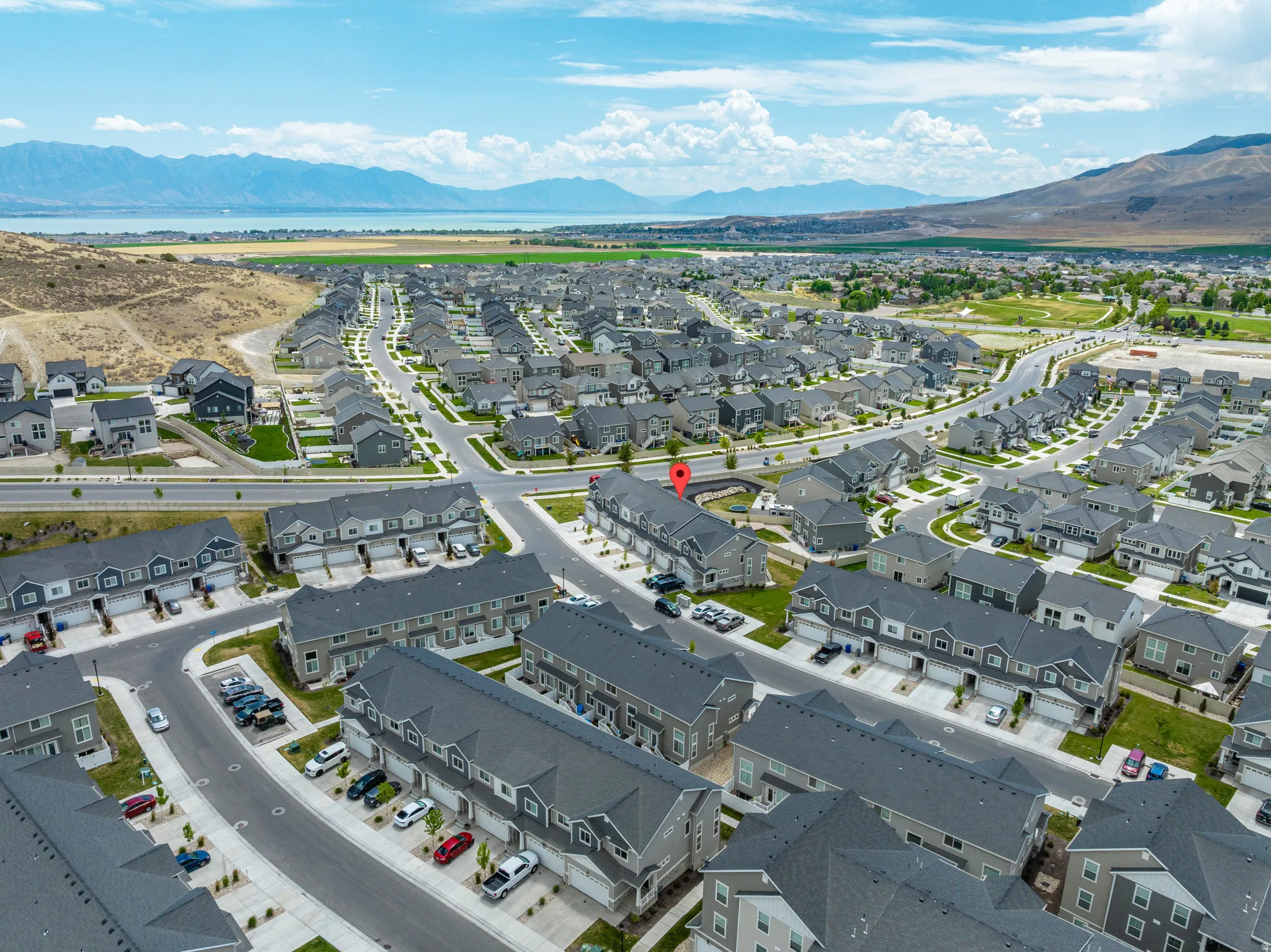 Aerial perspective showcasing a residential community with single-family homes and townhomes