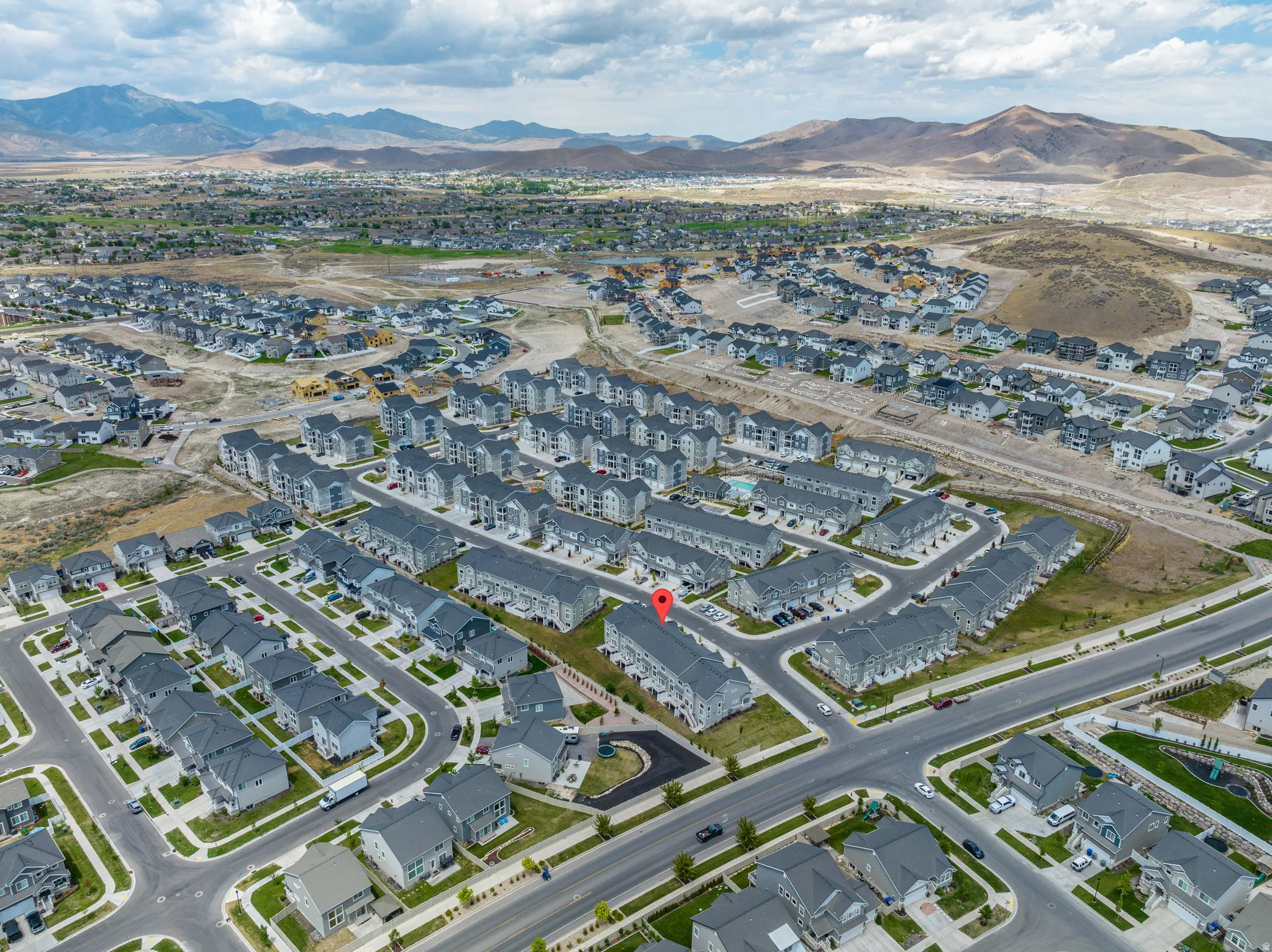 Aerial perspective showcasing a residential community with a mountain backdrop