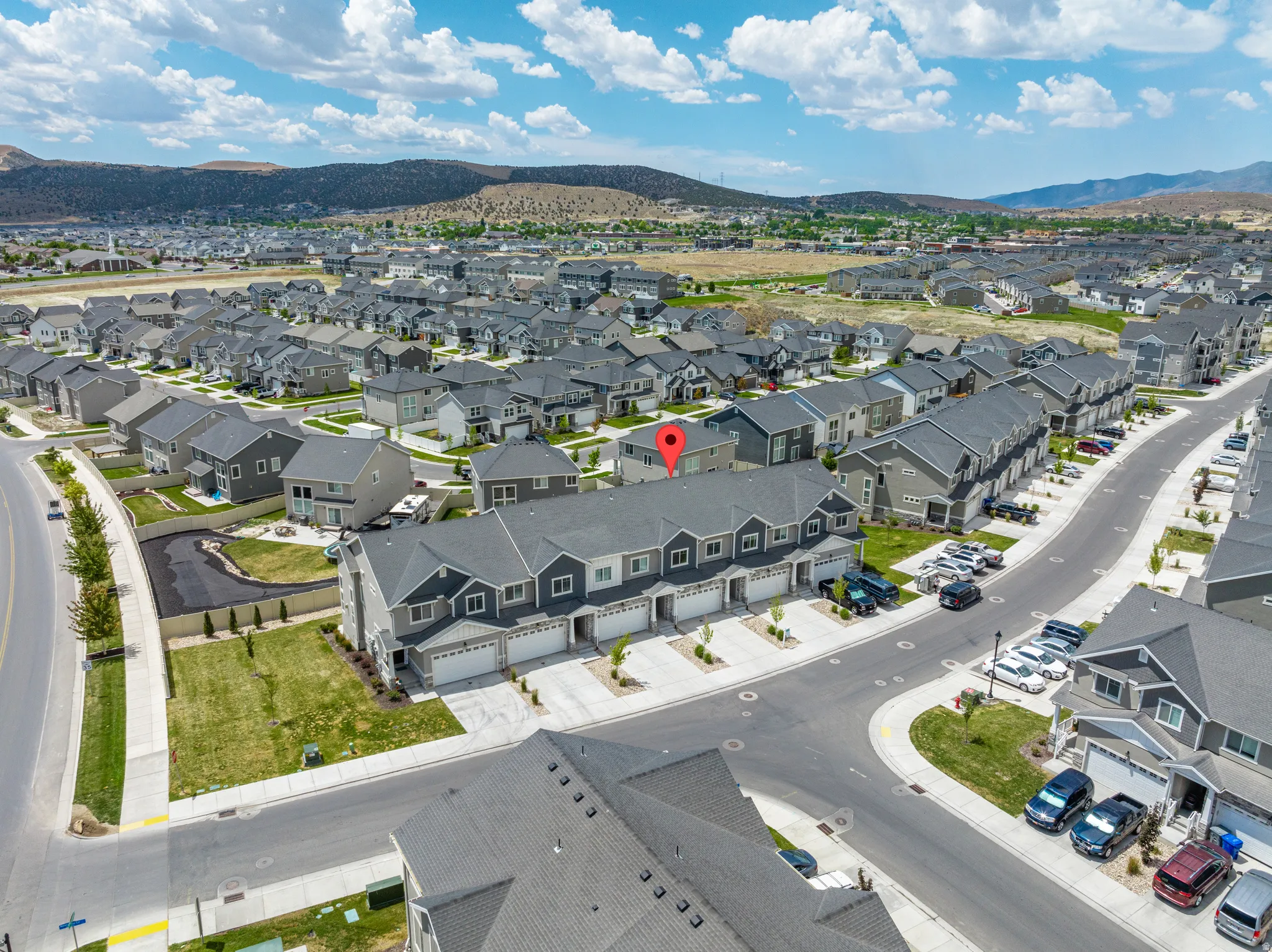 Aerial perspective showcasing a residential area with mountains in the background