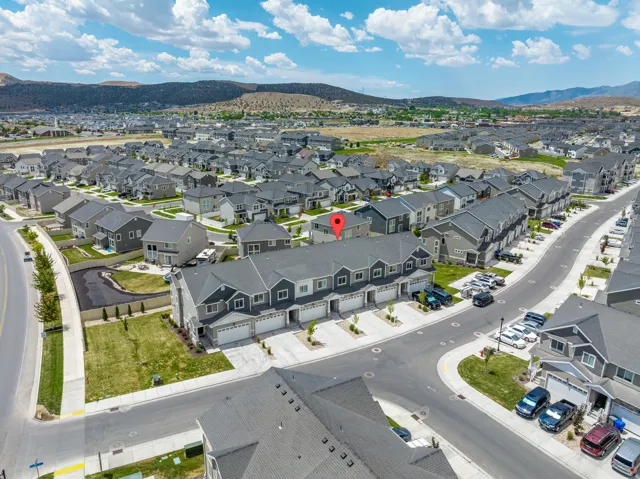 Aerial perspective showcasing a residential area with mountains in the background