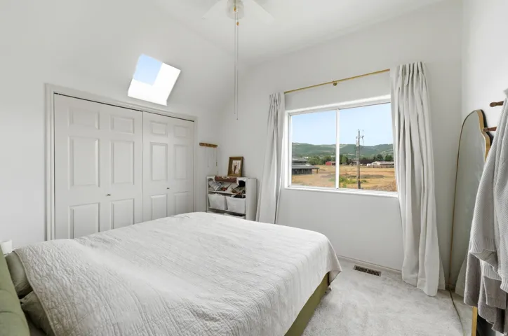 Vaulted ceiling with skylight and ceiling fan