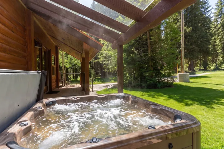 Relax and enjoy the scenery in the covered outdoor hot tub