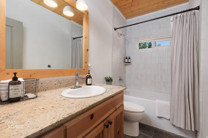 Bathroom with beautifully updated tiled shower/bath.