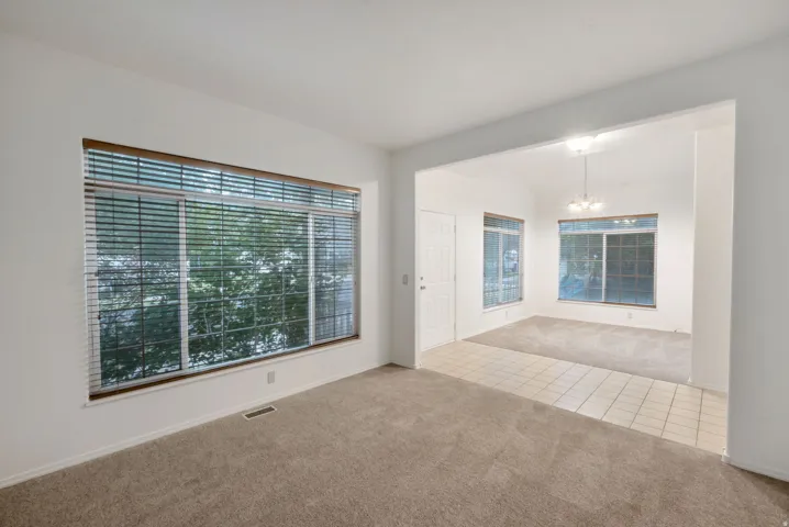 Bright interior space with large windows featuring horizontal blinds