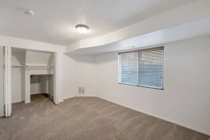 Neutral-toned carpeting and light-colored walls define this room
