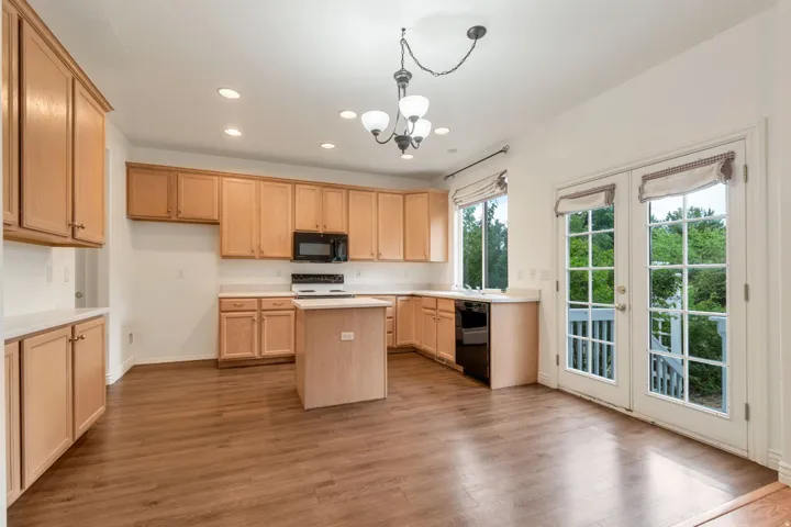 Kitchen featuring wood-finish flooring, recessed lighting, and a central island