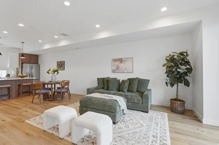 Open-concept living space with wood-finish flooring and recessed lighting