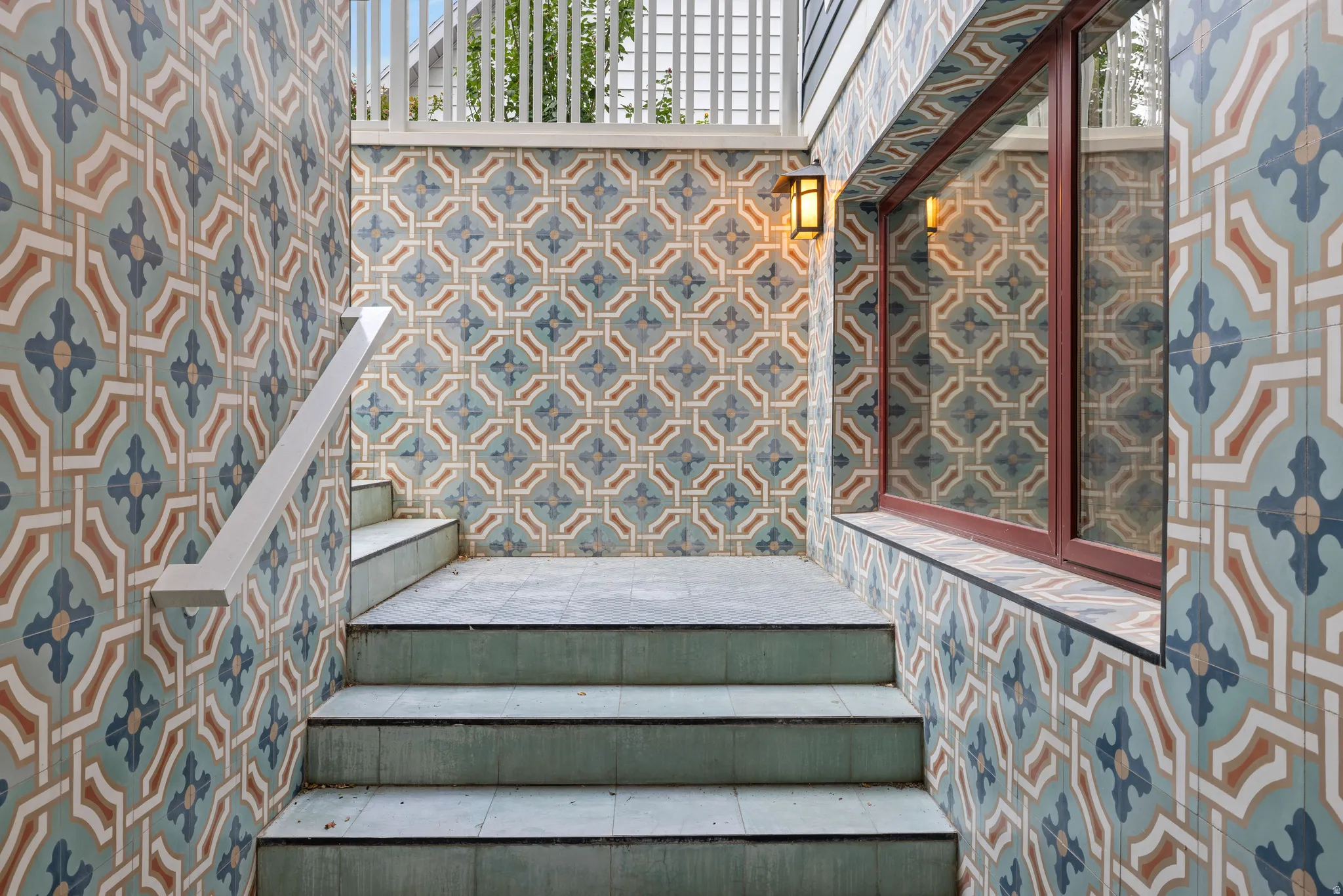 Basement entrance tiled exterior walls featuring an intricate geometric pattern