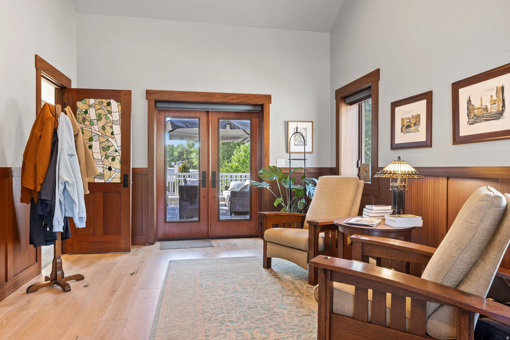 Entryway featuring hardwood flooring and natural wood wainscoting