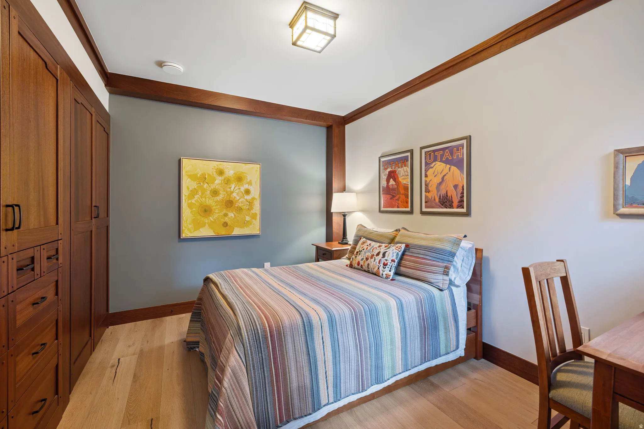 Warm wood-finish flooring complements custom built-in cabinetry and contrasting wall paneling