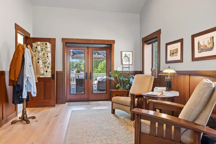 Entryway featuring hardwood flooring and natural wood wainscoting