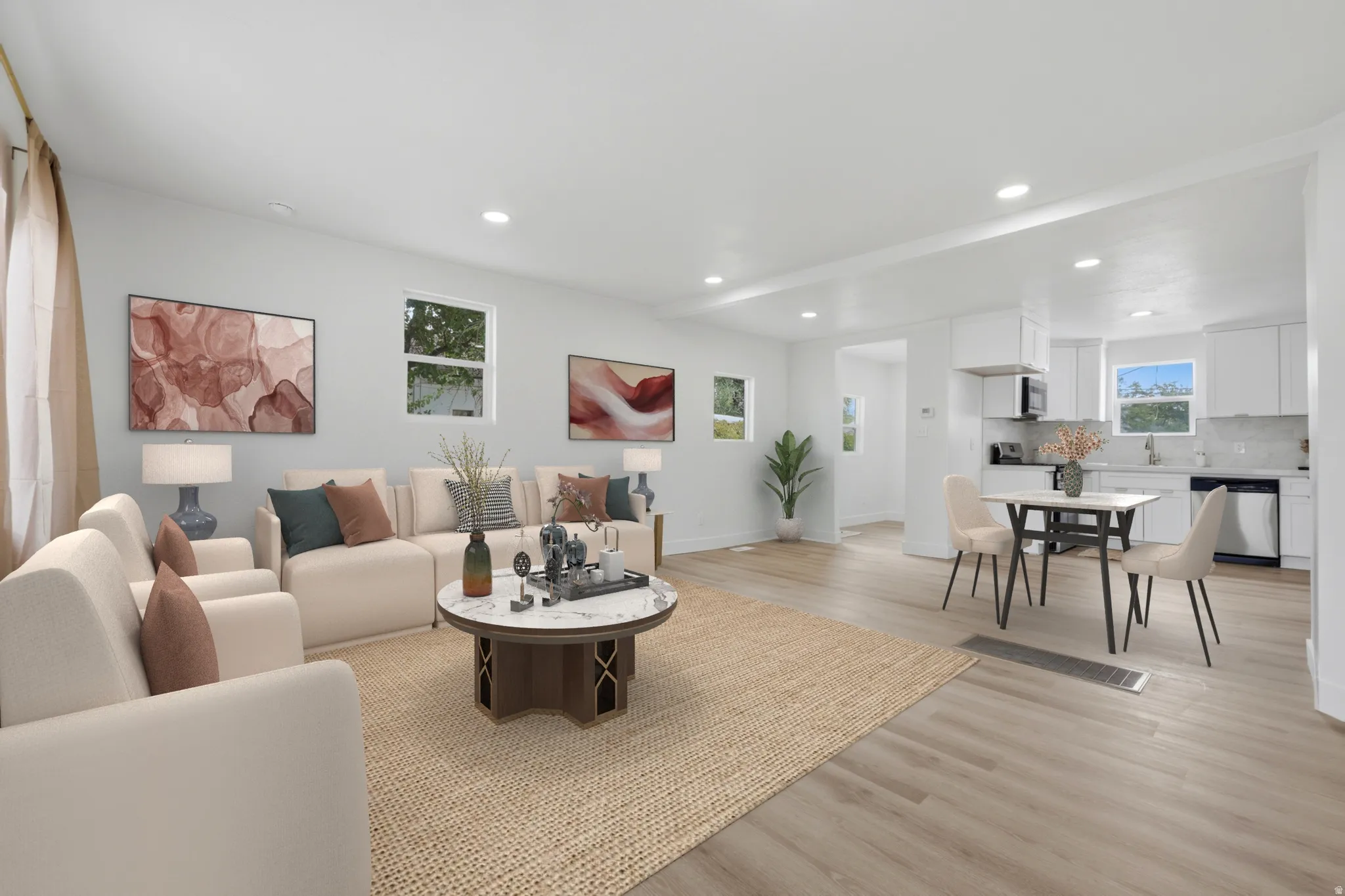 Open-concept living space featuring wood-finish flooring and recessed lighting