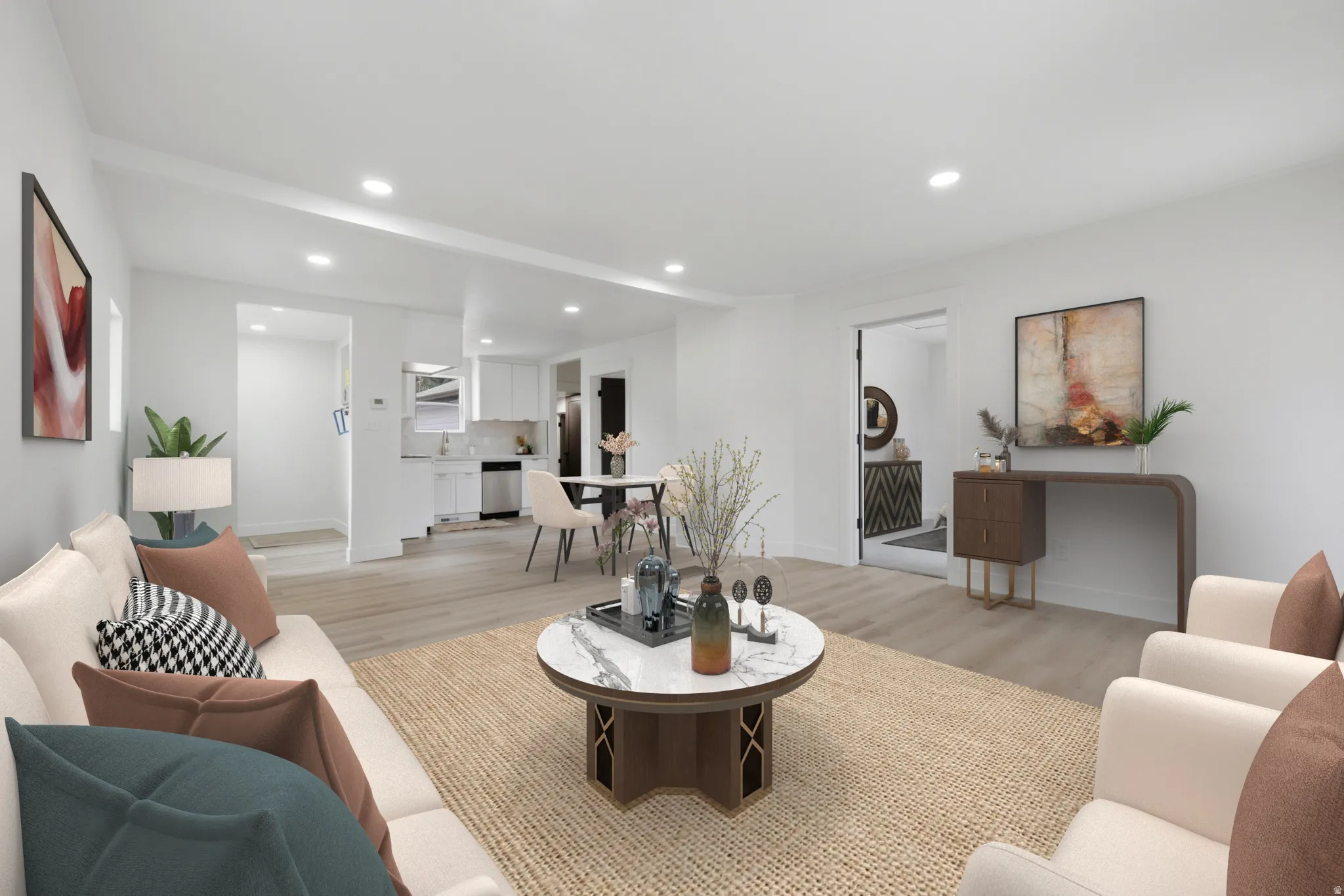 Spacious living area featuring light wood-finish flooring, recessed lighting, and a neutral color palette