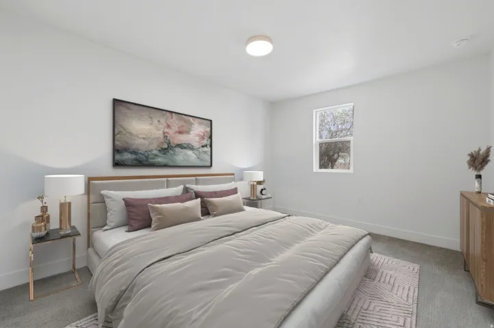 Bright room featuring light gray walls, a single window with white trim, and light gray carpet flooring