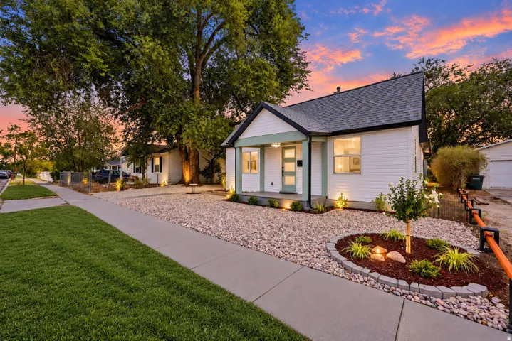 White siding exterior with a dark shingle roof