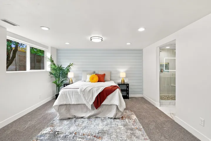 Bedroom featuring a light blue horizontal plank accent wall and recessed lighting