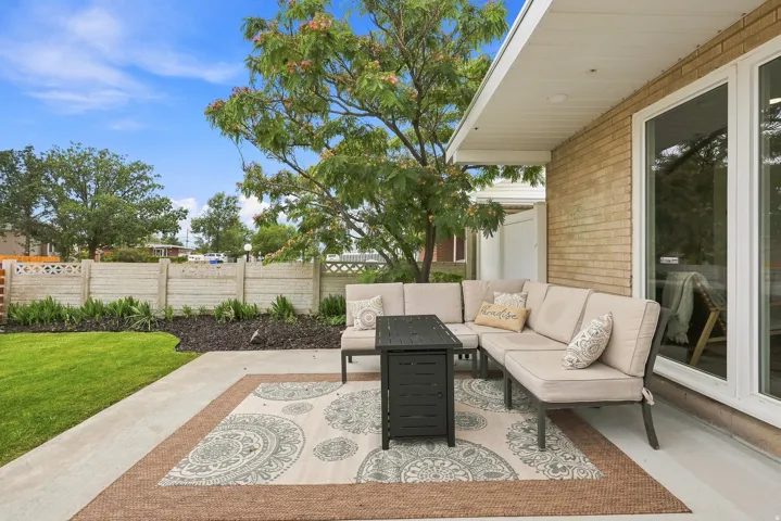 Exterior patio area featuring a concrete surface and an overhead covering