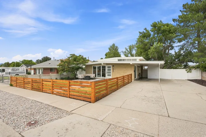 Mid-century modern residence featuring a light brick exterior and a flat roofline