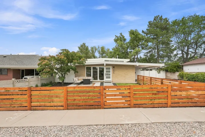 Mid-century modern exterior featuring a light-colored brick facade and a flat roofline