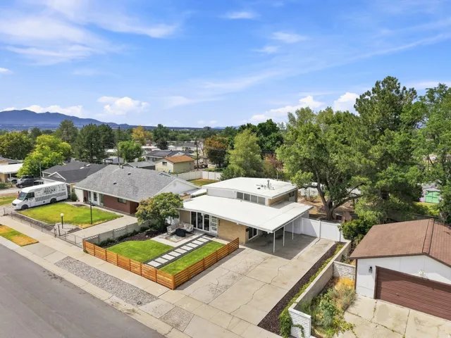 Mid-century modern residence featuring a flat roofline and a carport