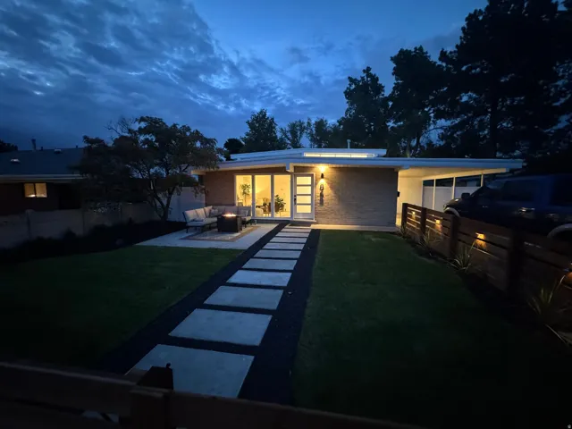 Mid-century modern exterior featuring a brick façade and a flat roofline