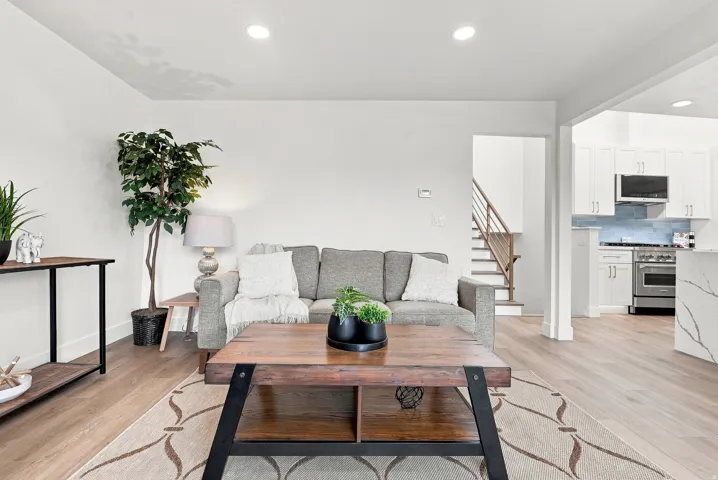Open-concept living space featuring light wood-finish flooring and recessed lighting