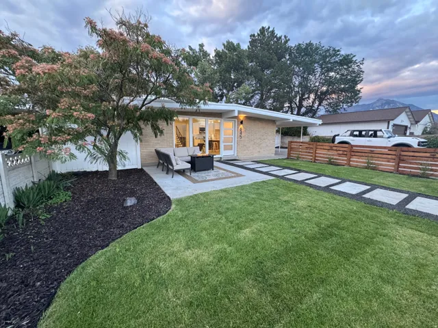 Mid-century modern exterior featuring a light brick façade and a flat roofline