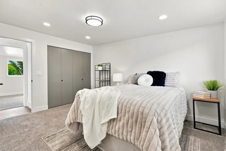 Spacious room featuring neutral carpeting and white walls