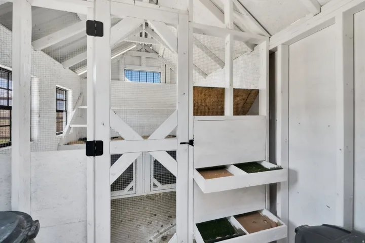 White-painted interior structure with exposed beams and cross-bracing
